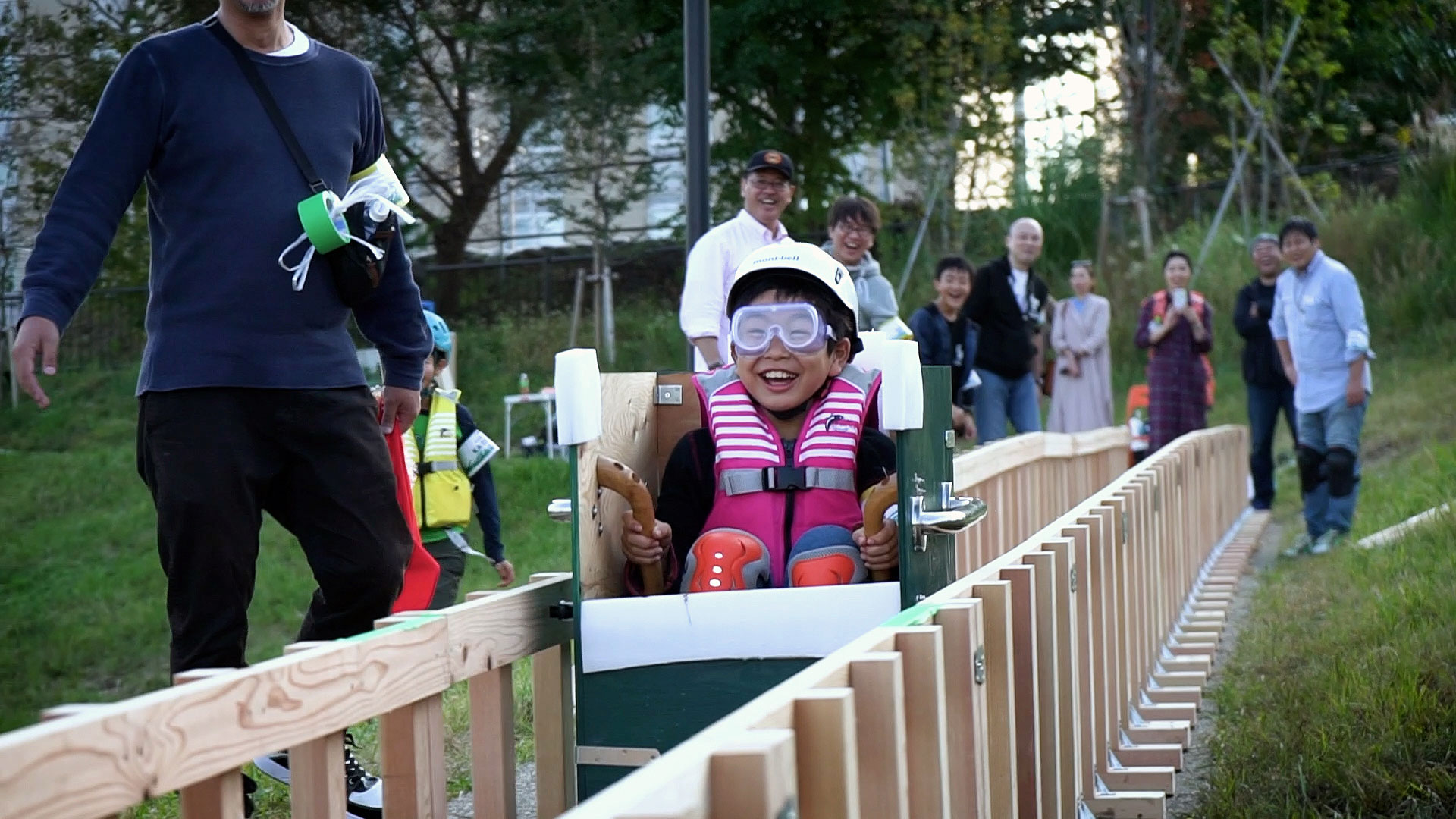 Kid having fun, sliding through self-made roller-coaster